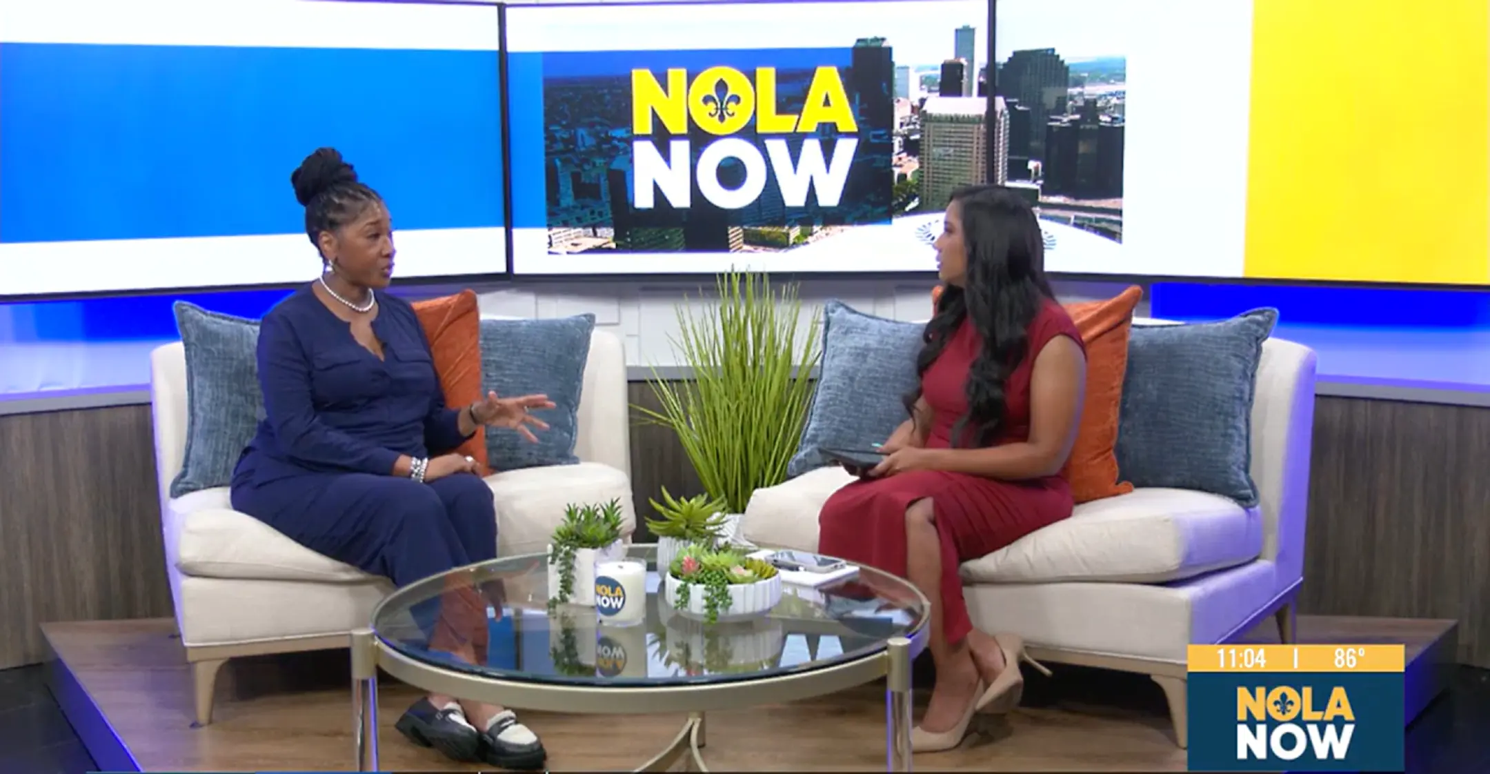 Two women sitting and talking on a news show